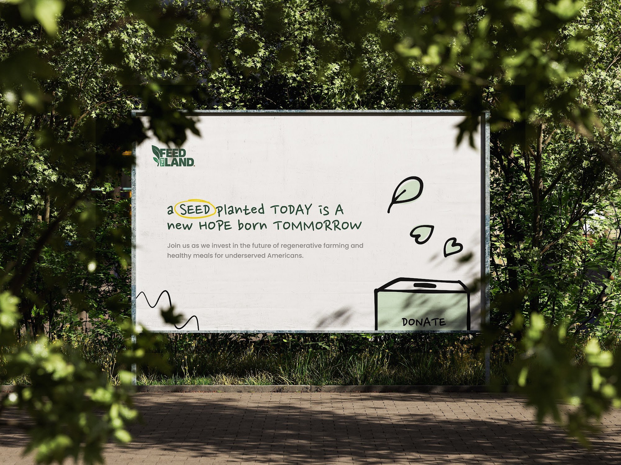 Feed The Land handwritten billboard framed by foliage